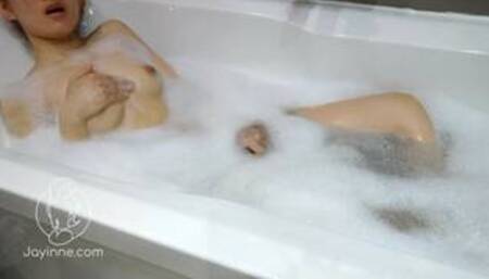 Petite asian girl Jayinne masturbates in foamy bathtub