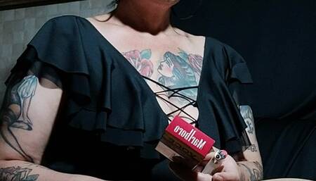 Wearing a black bodysuit, nylons, smoking a Marlboro Red, opening and closing her legs