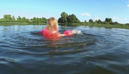 Alla swims on the lake and wears a pink inflatable vest and inflatable armbands for safety!!!