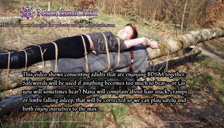 Girl tied to tree log in public forest, breath control and teasing to orgasm