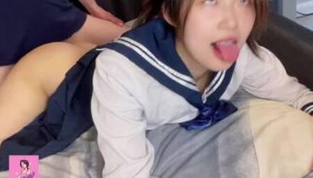 Young Asian with Japanese schoolgirl uniform being fucked from behind while watching cartoon