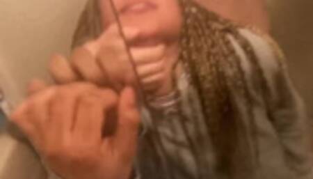 Blasian bent over bathroom sink while roommates in other room