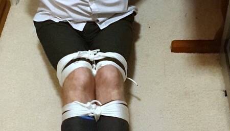 Tightly bound and gagged man in adult school uniform made to hop to room