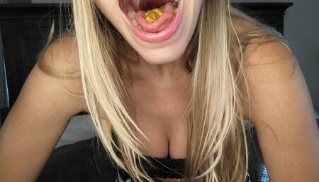 Open mouth swallowing gummy bears