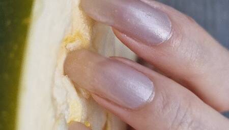 Scratching zucchini with long natural nails