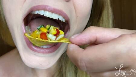 Colorful salad with nachos closeup chewing full HD mp4