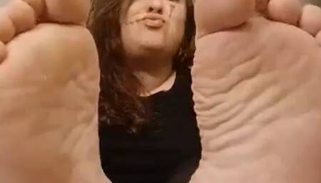 Showing my meaty soles with my tongue out