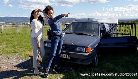 Two friend revving up old car