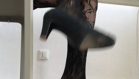 Dasha Kelly is reading a magazine and is bored she hits hard with her foot on the floor and dangles her pumps  in a sexy way