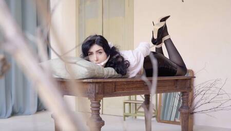 Helpless girl in bondage on the table