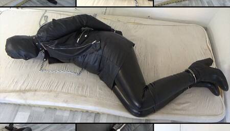 Leather captive in handcuffs and with a bondage hood
