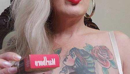 Blonde milf, red mouth, wearing a very sexy transparent bra, while inhaling and exhaling her red Marlboro