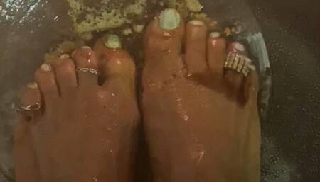 Oily barefoot food crush with white nail polish