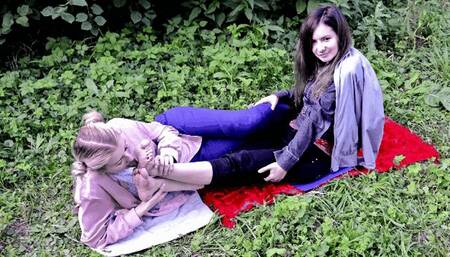 Shy poor girl Anetta licks gothic Eva's feet in a public park (Part 6 of 6)