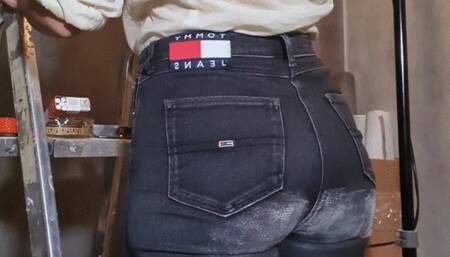 Renovating an apartment in jeans and a shirt (smoking on a building ladder)
