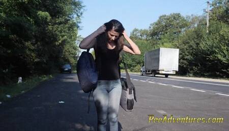 Skinny brunette hitchhiking  with her bladder full