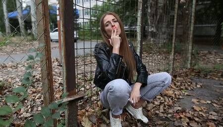 Natasha smokes outdoors