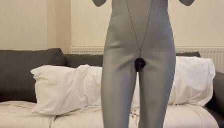 scuba teaser wearing silver neoprene wetsuit , oval mask breathing from scuba tank