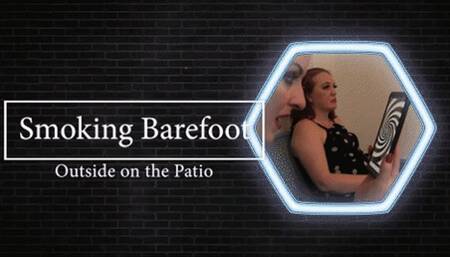 Eve smoking barefoot on the Patio
