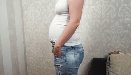 Bloated after dinner in tight jeans and shirt