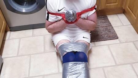 Footballer duct taped on kitchen floor 2