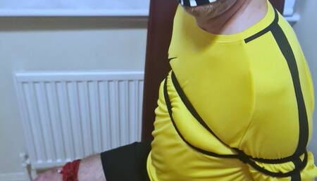 Footballer in yellow and black kit struggling to get out of tight bondage 3