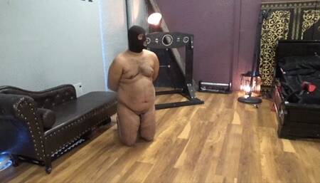 The ladies beat their hooded slave with their boots