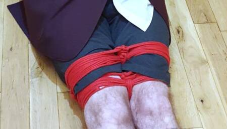 Man in adult school uniform bound and gagged on kitchen floor