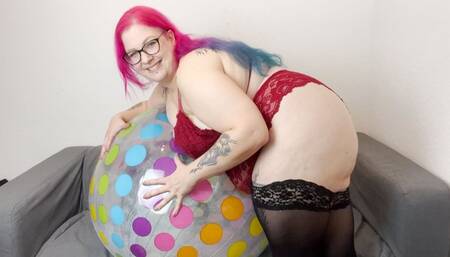 Inflating a large beach ball and posing with it