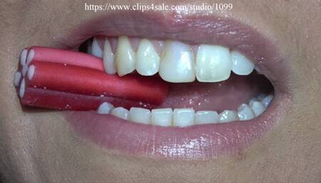 Woman chewing candys close to camera