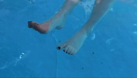 He films my small feet and wrinkled soles while i'm chilling in a swimming pool