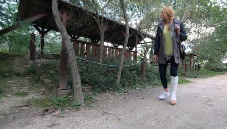 Katharina broke her leg. now she go to the partk and limping in short leg walking cast.