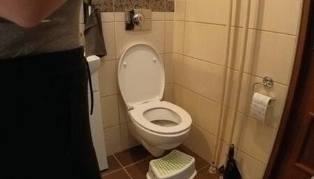 Sitting side on a toilet