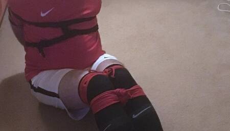 Footballer bound and gagged tight and squirming on floor