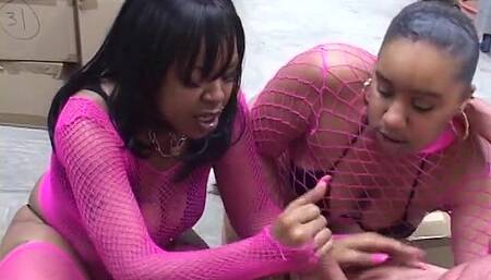 Two hungry ebony MILFs in fishnets share white dude's cock in an office