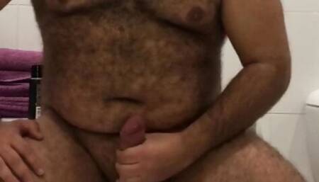 Dildo-riding bear jerking off uncut cock