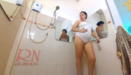 Nice lady in the shower room rubs cosmetic massage lotion oil on her beautiful legs. cam 2 2