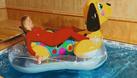Alla deflates an inflatable puppy in a boat and wears a red latex catsuit!!!