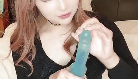She sucks the dildo hard in her mouth