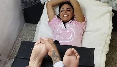 Genesis is tickled on her soles