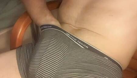 The guy in the room masturbates in the chair to a hot gay porn and cum on the table