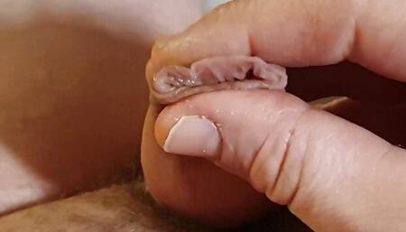 Slimy glans and foreskin play with the limp dick.