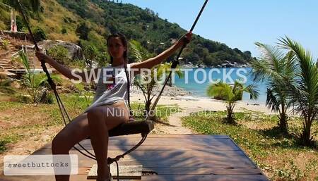 Rides on a swing without panties on the beach of Thailand