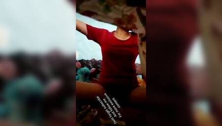 Girl wearing a red dress ripping batik cloth