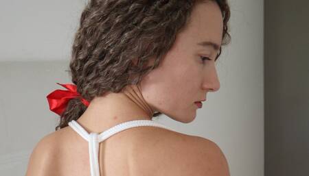Sofi tied with white ropes dancing on the bed