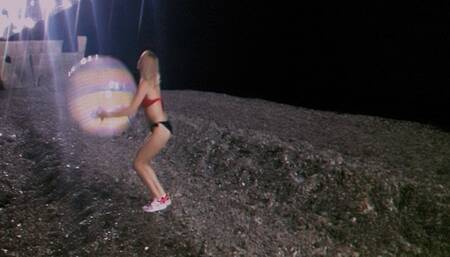 Alla plays with a big transparent beach ball on the night beach!!!