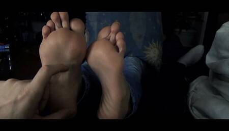 The girl next door tries to ignore foot tickling