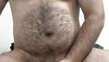 Hairy bear sticks dildo up his ass and shoots a full load of cum