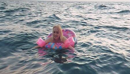 Alla swims in the sea with an inflatable ring and inflatable arm bands for safety!!!