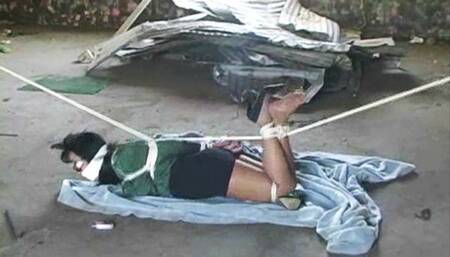 Gina hogtied and tethered in the abandoned warehouse